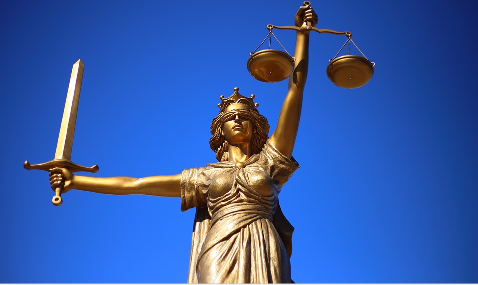 Statue of a blind folded woman holding a scale and on the right a sword